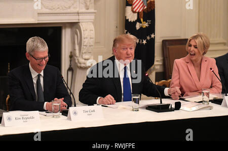First Daughter and Advisor to the President Ivanka Trump (R) reacts as United States President Donald J. Trump holds her hand and Apple CEO Tim Cook attends the American Workforce Policy Advisory Board meeting, at the White House, Washington, DC, March 6, 2019. The board consists of 25 members outside government, representing leading companies, academics and elected leaders. Credit: Mike Theiler/CNP /MediaPunch Stock Photo