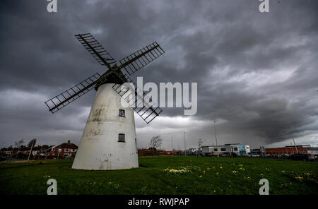 Dark clouds form over the Little Marton Windmill in Blackpool. Stock Photo