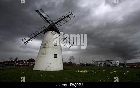 Dark clouds form over the Little Marton Windmill in Blackpool. Stock Photo