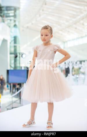 Kyiv, Ukraine March 03.2019. UKFW. Ukrainian Kids Fashion Day. Little girl wearing at pastel dress posing at podium Stock Photo