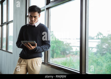 young asian businessman using tablet Stock Photo