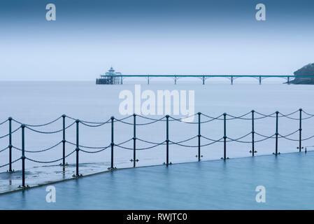 The Marine Lake at Clevedon with the Victorian pier in the Severn Estuary beyond. North Somerset, England. Stock Photo