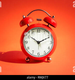 Close up red alarm clock on red background.timing concepts Stock Photo
