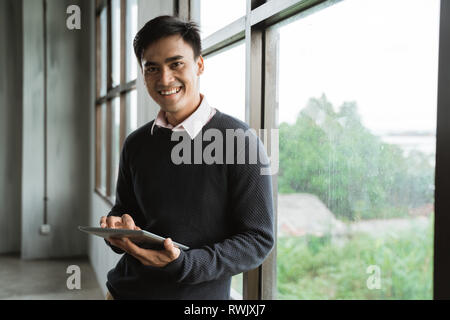 asian young businessman using tablet pc Stock Photo