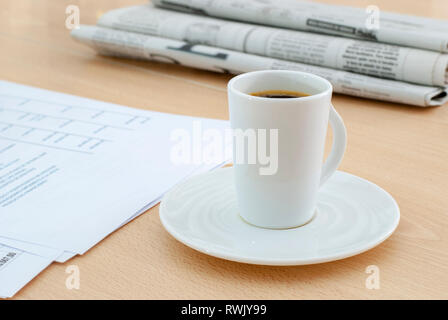 office desk table with cup of coffee and  planning agenda for input the text and newspapers Stock Photo