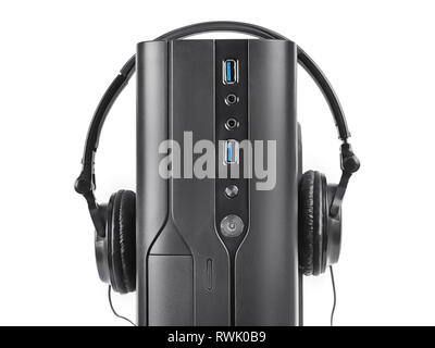 Black PC case close up with head earphones on it. Isolated on white, clipping path included Stock Photo