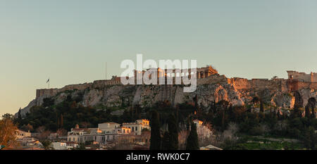 Acropolis of Athens Greece rock and Parthenon on blue sky background in the evening. View from Monastiraki area Stock Photo