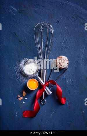 Baking or cooking background frame. Ingredients, kitchen items for baking cakes. Kitchen utensils, flour, eggs. Text space, top view. Stock Photo
