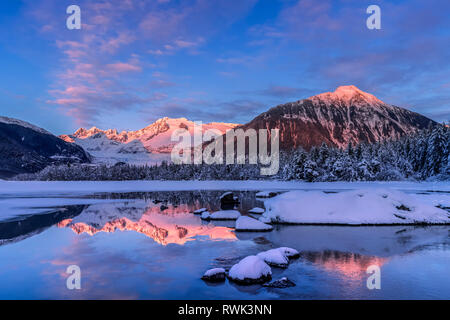 Winter afternoon sunset along the shoreline of Mendenhall River, Tongass National Forest; Alaska, United States of America Stock Photo