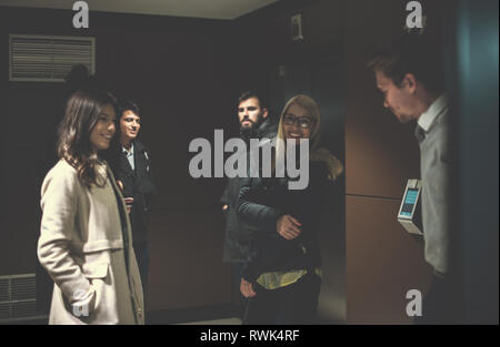 group of young multiethnic startup business team having a coffee break at the hallway in front of office Stock Photo