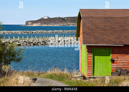 Rocky Harbour wharf and breakwater as seen from the southern end of the Town of Rocky Harbour, Newfoundland, Canada. Far in the background is the Lobster Cove Head Lighthouse. Stock Photo