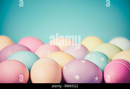 Colorful Easter Eggs border on a teal blue background with subtle vintage styling Stock Photo