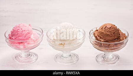 Three bowls with chocolate, strawberry and vanilla Ice-cream. Stock Photo
