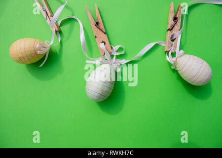 Gradient colored easter chicken eggs on green isolated background. stylish composition, copy space,postcard for Happy easter.Easter composition Stock Photo