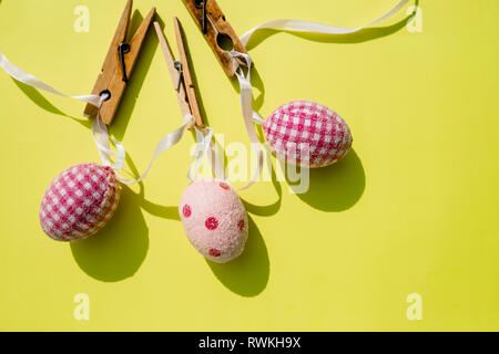 Eggs painted various patterns for Easter holiday. Yellow bright background, copy space, minimalistic concept.Stylish Candy color easter eggs .Spring Stock Photo