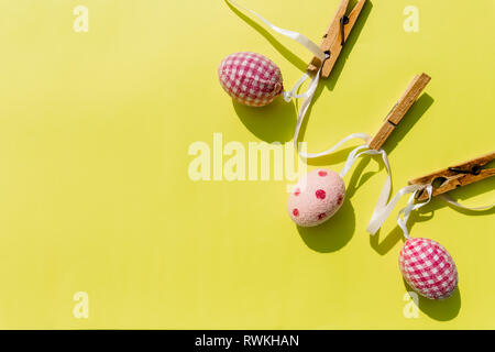 Eggs painted various patterns for Easter holiday. Yellow bright background, copy space, minimalistic concept.Stylish Candy color easter eggs .Spring Stock Photo