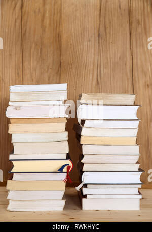 Stack of books on wooden background Stock Photo