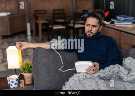 Nice young man holding a special device Stock Photo