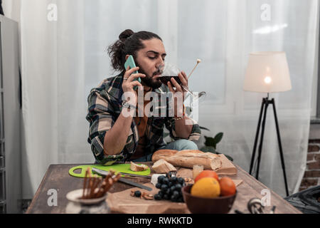 Nice pleasant having taking a sip of wine Stock Photo