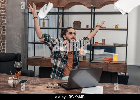 Sad depressed man being tired from work Stock Photo