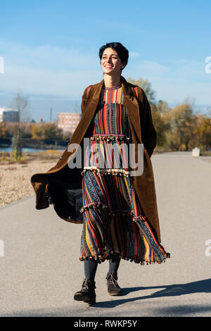 Woman walking along Rhine River, Strandbad, Mannheim, Germany Stock Photo