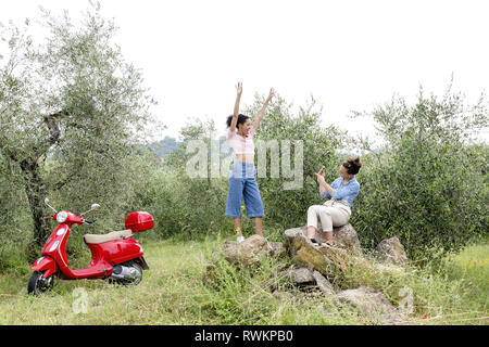 Friends taking photo in olive grove, Città della Pieve, Umbria, Italy Stock Photo