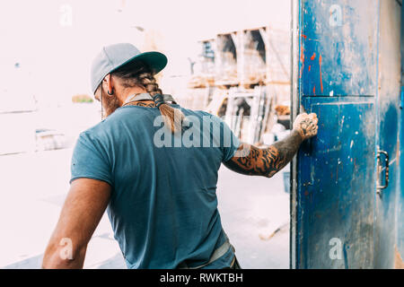 Man closing warehouse door Stock Photo