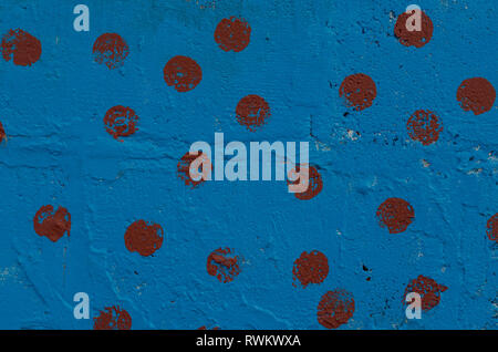 The section of the wall, painted with blue paint with burgundy patches Stock Photo
