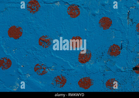 The section of the wall, painted with blue paint with burgundy patches Stock Photo