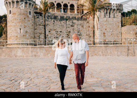 Couple taking walk on beach, Estoril, Lisboa, Portugal Stock Photo