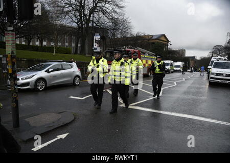Police officers are seen patrolling near the area of scene. Police have found a suspicious package at Glasgow University in Scotland. Police and Campus Staff have shut the area down for the time being. Stock Photo