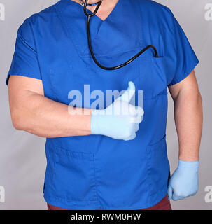 doctor in blue uniform shows a gesture of approval, like. Gray background Stock Photo