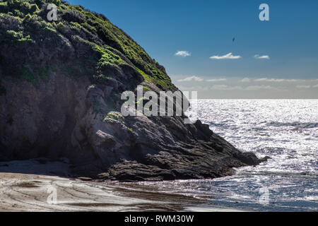 Picturesque coastal view of giant cliffs at Stands Beach on a sunny day with reflections in the water, Dana Point, California Stock Photo