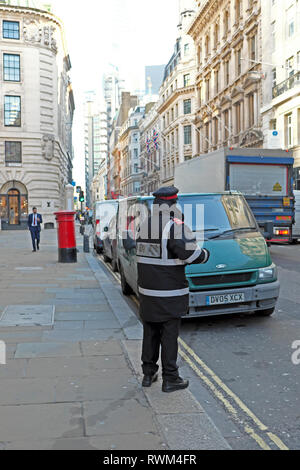 A parking attendant giving ticket to a van parked on double yellow lines in  business district on Cornhill in City of London UK    KATHY DEWITT Stock Photo