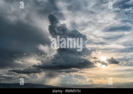 Cumulonimbus cloud building over the city of Cochabamba, Bolivia. Inspirational lighting coming from behind the cloud; Cochabamba, Bolivia Stock Photo