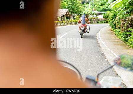 Men on motorbike road trip, Pagudpud, Ilocos Norte, Philippines Stock Photo