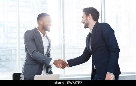 Business executives shaking hands Stock Photo - Alamy