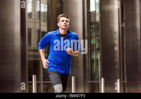 Young runner jogging in city square, London, UK Stock Photo