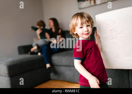 Mother and sons in living room Stock Photo