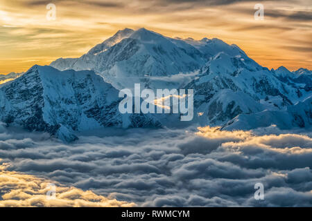 Aerial image of the Saint Elias mountains in Kluane National Park and Reserve. This is Mount Logan, Canada's highest peak rises above the storm clo... Stock Photo