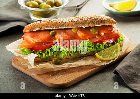 Sandwich with smoked salmon salad and tomato. Healthy food. Stock Photo