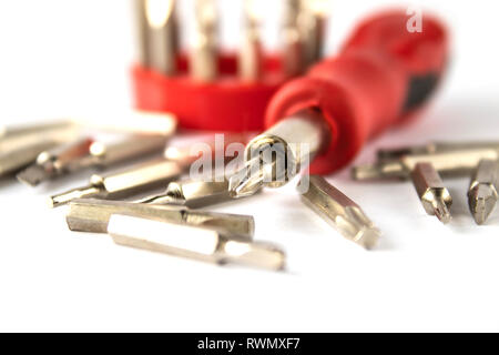 A set of bits for screwdrivers on a white background. A set of bits for repair and electronics. Stock Photo