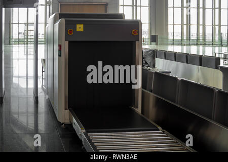 Airport terminal luggage X-ray machine for security scanning search Stock Photo