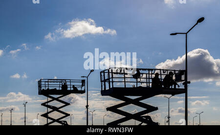 Street lamp repair workers on lift platform Stock Photo