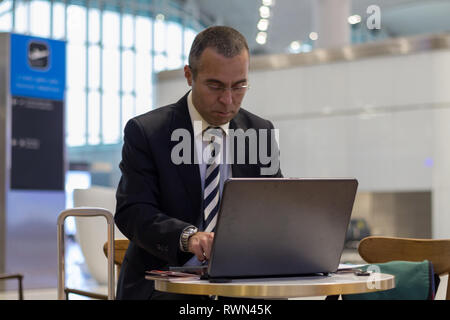 Passenger business man working with laptop at the airport Stock Photo