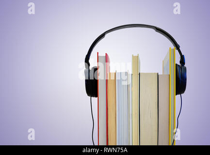 Headphones over books. Reading and Audio books concept Stock Photo