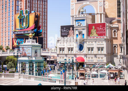 LAS VEGAS, NEVADA - MAY 15, 2018: Street view of Treasure Island Resort Casino and The Venetian Resort Hotel Casino with colorful signs, Grand Canal a Stock Photo