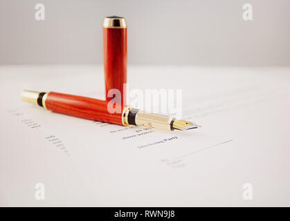 Elegant gold plated business fountain pen on a non disclosure agreement (NDA) Stock Photo