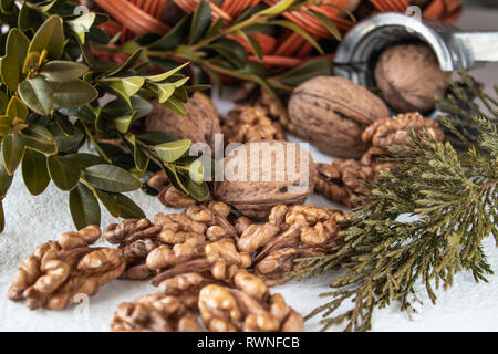 Walnuts and kernels of nuts on a white background near the basket. Stock Photo
