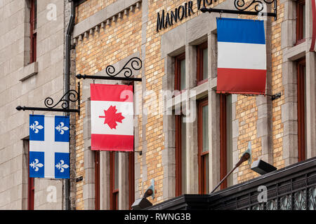 The National Flags of Canada and France hanging with the provincial flag of Quebec in Quebec City. Stock Photo